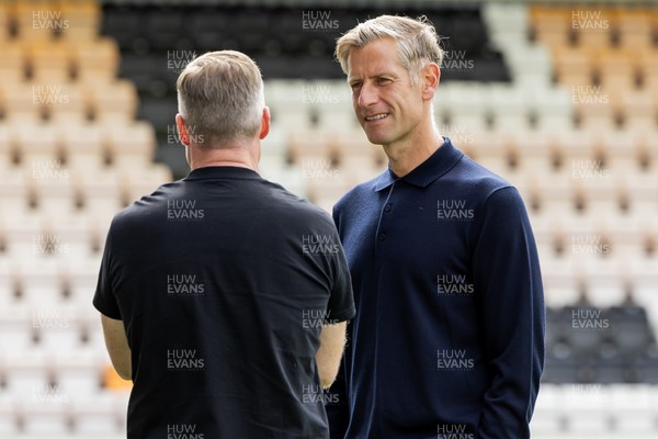300825 - Cambridge United v Newport County - Sky Bet League 2 - Newport County manager David Hughes speaks to Cambridge United manager Neil Harris 