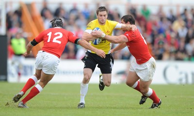 30.05.09 - Canada v Wales - Wales' Andrew Bishop is tackled by Canada's Ryan Smith and Aaron Carpenter. 