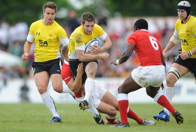 30.05.09 - Canada v Wales - Wales' Andrew Bishop is held by the Canadian defence. 