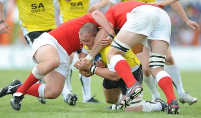 30.05.09 - Canada v Wales - Wales' Craig Mitchell is held by the Canadian defence. 