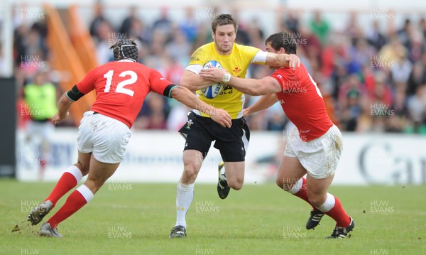 30.05.09 - Canada v Wales - Wales' Andrew Bishop is tackled by Canada's Ryan Smith and Aaron Carpenter. 
