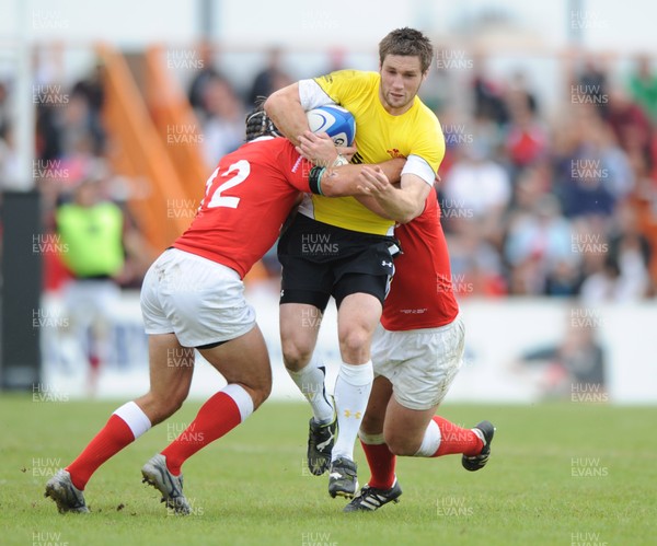 30.05.09 - Canada v Wales - Wales' Andrew Bishop is tackled by Canada's Ryan Smith and Aaron Carpenter. 