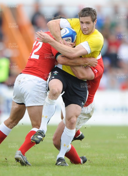 30.05.09 - Canada v Wales - Wales' Andrew Bishop is tackled by Canada's Ryan Smith and Aaron Carpenter. 