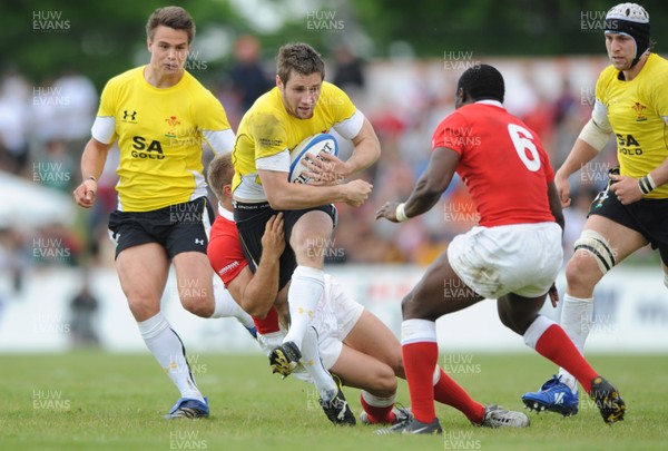 30.05.09 - Canada v Wales - Wales' Andrew Bishop is held by the Canadian defence. 