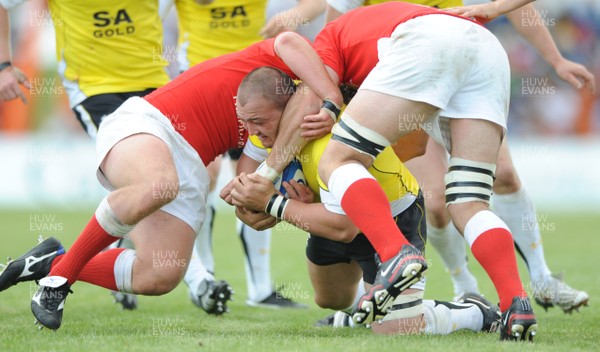 30.05.09 - Canada v Wales - Wales' Craig Mitchell is held by the Canadian defence. 