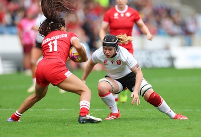 300825 - Canada v Wales, Women’s Rugby World Cup - Bethan Lewis of Wales looks to tackle Asia Hogan-Rochester of Canada