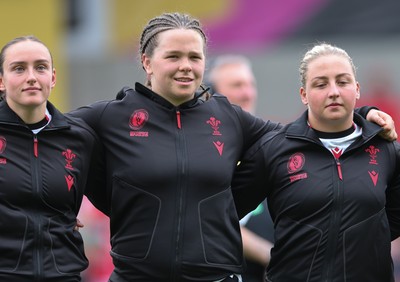 300825 - Canada v Wales, Women’s Rugby World Cup - Left to right, Nel Metcalfe, Maisie Davies and Molly Reardon of Wales line up for the anthems