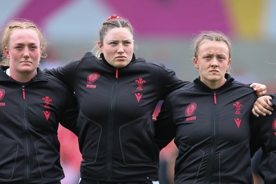 300825 - Canada v Wales, Women’s Rugby World Cup - Left to right, Abbie Fleming, Gwen Crabb and Lleucu George of Wales line up for the anthems