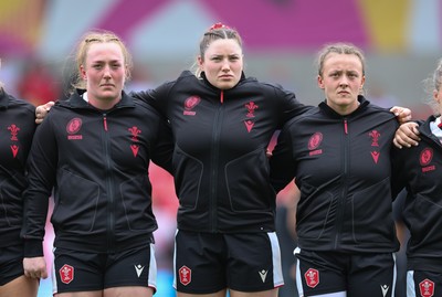 300825 - Canada v Wales, Women’s Rugby World Cup - Left to right, Abbie Fleming, Gwen Crabb and Lleucu George of Wales line up for the anthems