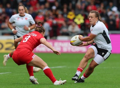 300825 - Canada v Wales, Women’s Rugby World Cup - Lleucu George of Wales takes on Justine Pelletier of Canada