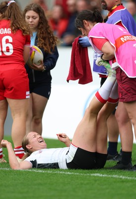 300825 - Canada v Wales, Women’s Rugby World Cup - Carys Cox of Wales receives treatment from Gwennan Williams, Wales Women team doctor