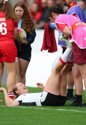 300825 - Canada v Wales, Women’s Rugby World Cup - Carys Cox of Wales receives treatment from Gwennan Williams, Wales Women team doctor