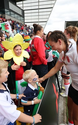 300825 - Canada v Wales, Women’s Rugby World Cup - Wales players with supporters at the end of the match