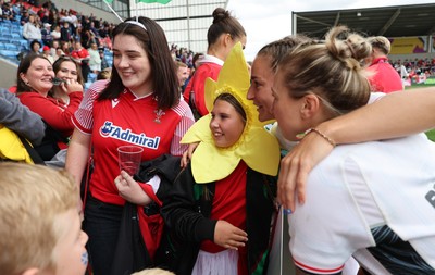 300825 - Canada v Wales, Women’s Rugby World Cup - Wales players with supporters at the end of the match