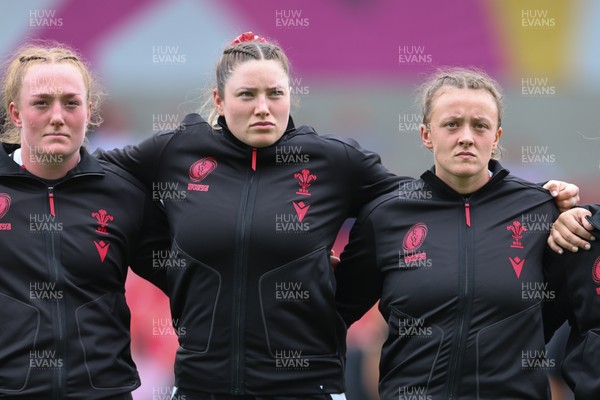300825 - Canada v Wales, Women’s Rugby World Cup - Left to right, Abbie Fleming, Gwen Crabb and Lleucu George of Wales line up for the anthems