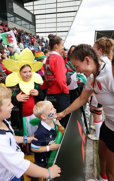 300825 - Canada v Wales, Women’s Rugby World Cup - Wales players with supporters at the end of the match