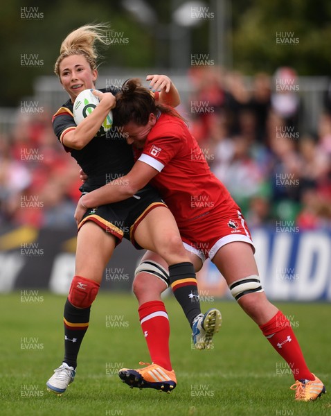 130817 - Canada v Wales - Women's Rugby World Cup - Elinor Snowsill of Wales is tackled by Jacey Grusnick of Canada