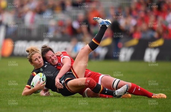 130817 - Canada v Wales - Women's Rugby World Cup - Elinor Snowsill of Wales is tackled by Jacey Grusnick of Canada