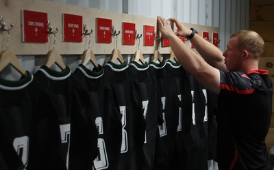 270822 - Canada Women v Wales Women, Summer 15’s World Cup Warm up match - Jamie Cox places the final name plaque on the wall in the changing room