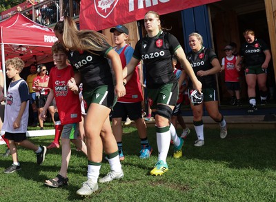 270822 - Canada Women v Wales Women, Summer 15’s World Cup Warm up match - Kayleigh Powell of Wales chats to one of the mascots as they walk out for the start of the match