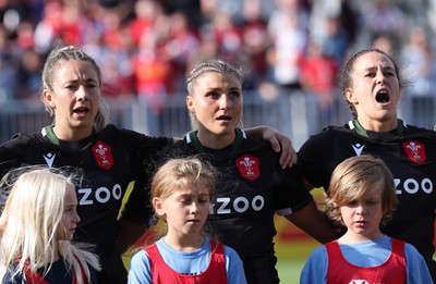 270822 - Canada Women v Wales Women, Summer 15’s World Cup Warm up match - Elinor Snowsill, Lowri Norkett and Ffion Lewis of Wales sing out the national anthem at the start of the match