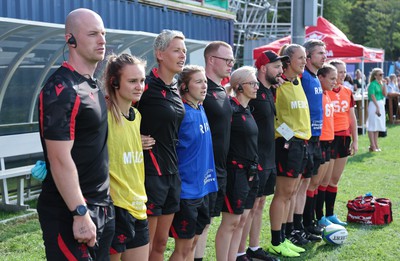 270822 - Canada Women v Wales Women, Summer 15’s World Cup Warm up match - members of the Wales management team sign the national anthem at the start of the match