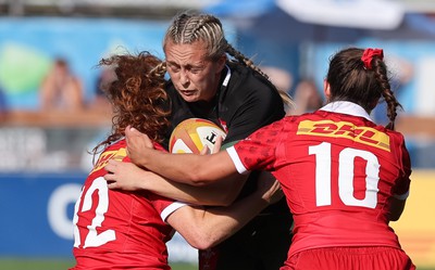 270822 - Canada Women v Wales Women, Summer 15’s World Cup Warm up match - Hannah Jones of Wales is tackled by Alexandra Tessier of Canada and Taylor Perry of Canada