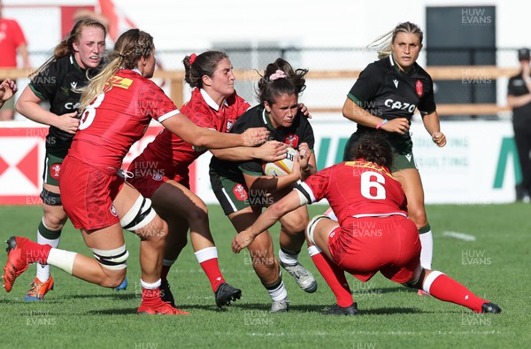 270822 - Canada Women v Wales Women, Summer 15’s World Cup Warm up match - Kayleigh Powell of Wales is tackled by Fabiola Forteza of Canada and Taylor Perry of Canada