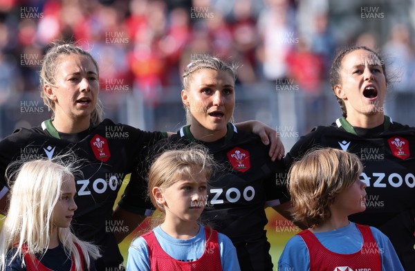 270822 - Canada Women v Wales Women, Summer 15’s World Cup Warm up match - Elinor Snowsill, Lowri Norkett and Ffion Lewis of Wales sing out the national anthem at the start of the match