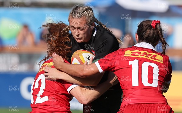270822 - Canada Women v Wales Women, Summer 15’s World Cup Warm up match - Hannah Jones of Wales is tackled by Alexandra Tessier of Canada and Taylor Perry of Canada