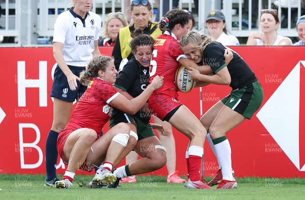 270822 - Canada Women v Wales Women, Summer 15’s World Cup Warm up match - Sioned Harries of Wales and Hannah Jones of Wales tackle Elissa Alarie of Canada