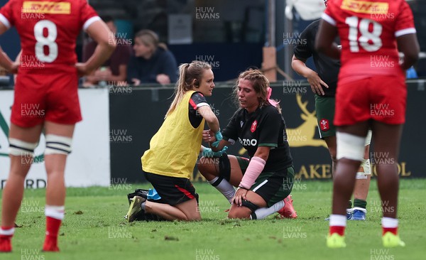 270822 - Canada Women v Wales Women, Summer 15’s World Cup Warm up match - Georgia Evans of Wales receives treatment from Cara Jones
