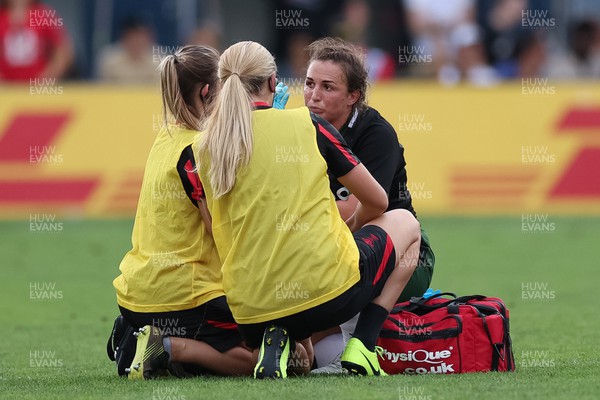 270822 - Canada Women v Wales Women, Summer 15’s World Cup Warm up match - Siwan Lillicrap of Wales receives treatment from Cara Jones and Jo Perkins