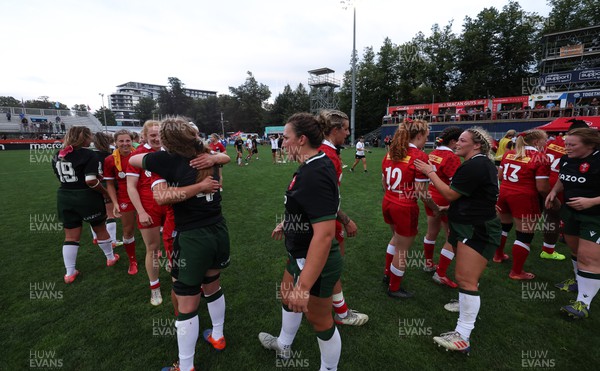 270822 - Canada Women v Wales Women, Summer 15’s World Cup Warm up match - Players embrace each other at the end of the match
