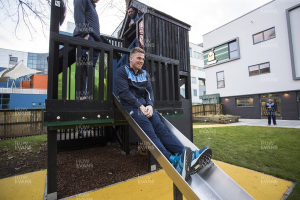 071217 - Cardiff Blues visit Ronald McDonald House at Noah's Ark Childrens Hospital at The Heath - Gareth Anscombe tries out the slide
