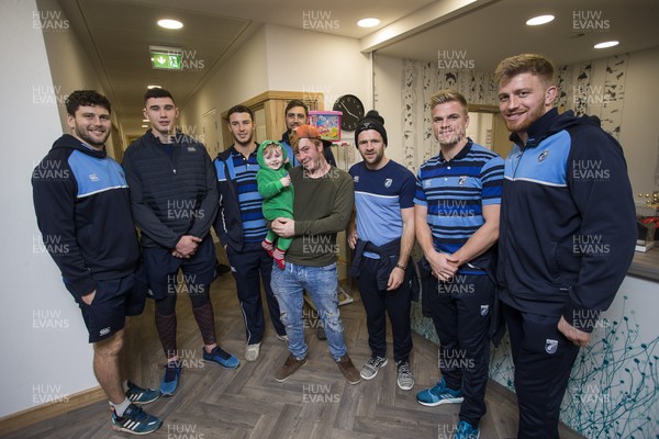 071217 - Cardiff Blues visit Ronald McDonald House at Noah's Ark Childrens Hospital at The Heath - Sion Bennett, Seb Davies, Steven Shingler, Josh Turnbull, Lewis Jones, Gareth Anscombe and Macauley Cook with Jamie Sheen and 13 month old son Jayden