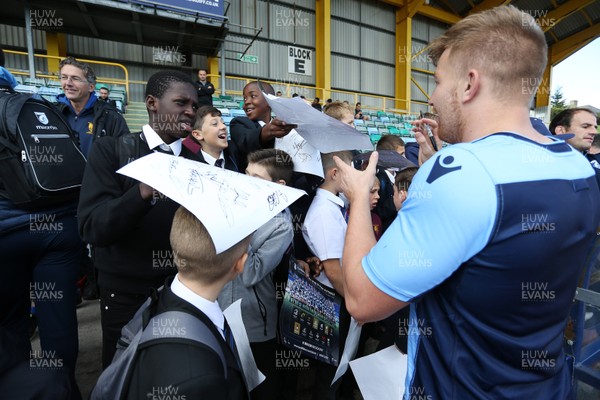 011018 - Cardiff Blues Open Training - Macauley Cook of Cardiff Blues signs autographs for local children