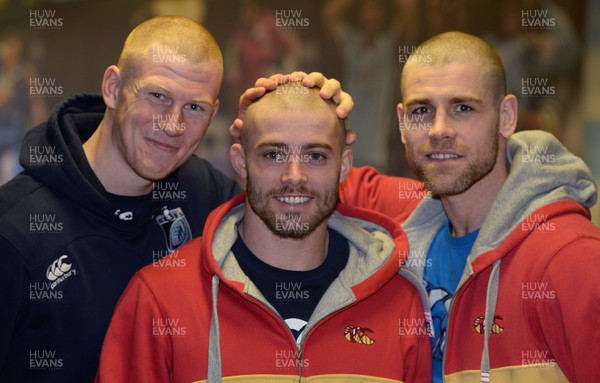 311213 - Cardiff Blues Charity Hair Shave -(L-R) Rhys Patchell, Leigh Halfpenny and Gavin Evans after having their heads shaved to raise money for Velindre in support of team Mattew Rees who is being treated for testicular cancer