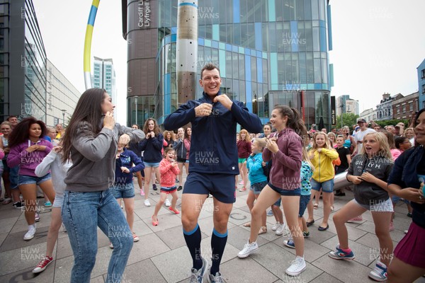 200713 - Cardiff Blues shirt launch - Cardiff Blues launch their new shirt for the 2013-14 season, with a flash mob dance routine featuring Blues player Robin Copeland outside Cardiff Library