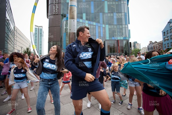 200713 - Cardiff Blues shirt launch - Cardiff Blues launch their new shirt for the 2013-14 season, with a flash mob dance routine featuring Blues player Robin Copeland outside Cardiff Library