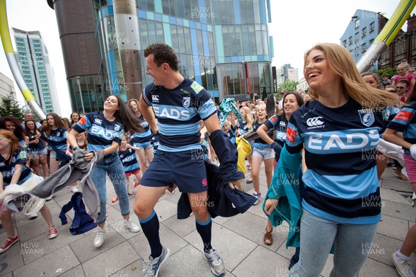 200713 - Cardiff Blues shirt launch - Cardiff Blues launch their new shirt for the 2013-14 season, with a flash mob dance routine featuring Blues player Robin Copeland outside Cardiff Library