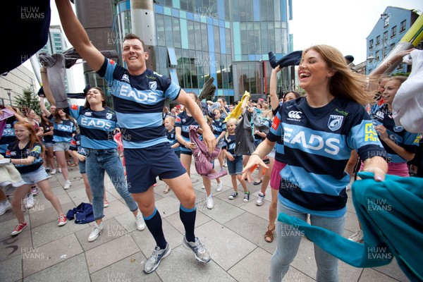 200713 - Cardiff Blues shirt launch - Cardiff Blues launch their new shirt for the 2013-14 season, with a flash mob dance routine featuring Blues player Robin Copeland outside Cardiff Library