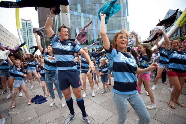 200713 - Cardiff Blues shirt launch - Cardiff Blues launch their new shirt for the 2013-14 season, with a flash mob dance routine featuring Blues player Robin Copeland outside Cardiff Library