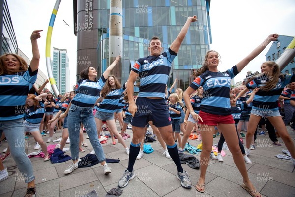 200713 - Cardiff Blues shirt launch - Cardiff Blues launch their new shirt for the 2013-14 season, with a flash mob dance routine featuring Blues player Robin Copeland outside Cardiff Library