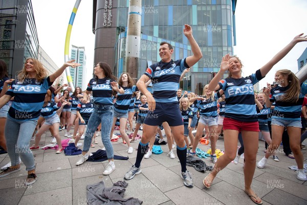 200713 - Cardiff Blues shirt launch - Cardiff Blues launch their new shirt for the 2013-14 season, with a flash mob dance routine featuring Blues player Robin Copeland outside Cardiff Library