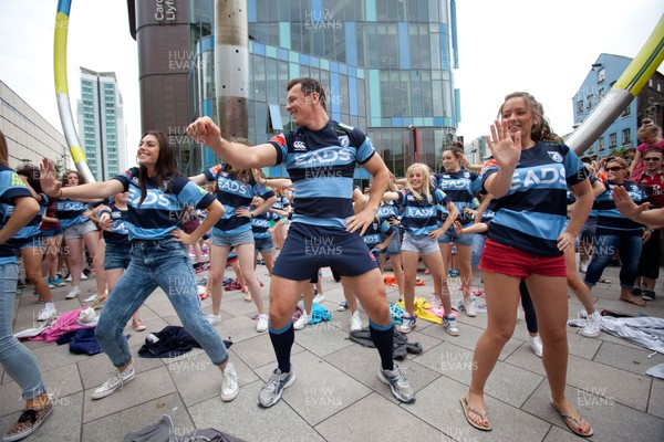 200713 - Cardiff Blues shirt launch - Cardiff Blues launch their new shirt for the 2013-14 season, with a flash mob dance routine featuring Blues player Robin Copeland outside Cardiff Library