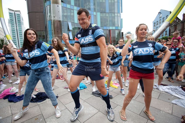 200713 - Cardiff Blues shirt launch - Cardiff Blues launch their new shirt for the 2013-14 season, with a flash mob dance routine featuring Blues player Robin Copeland outside Cardiff Library