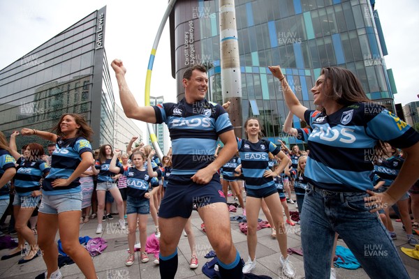 200713 - Cardiff Blues shirt launch - Cardiff Blues launch their new shirt for the 2013-14 season, with a flash mob dance routine featuring Blues player Robin Copeland outside Cardiff Library