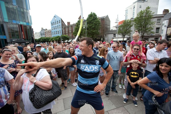 200713 - Cardiff Blues shirt launch - Cardiff Blues launch their new shirt for the 2013-14 season, with a flash mob dance routine featuring Blues player Robin Copeland outside Cardiff Library