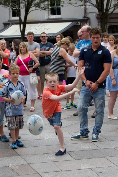 200713 - Cardiff Blues shirt launch - Cardiff Blues launch their new shirt for the 2013-14 season, with a flash mob dance routine outside Cardiff Library